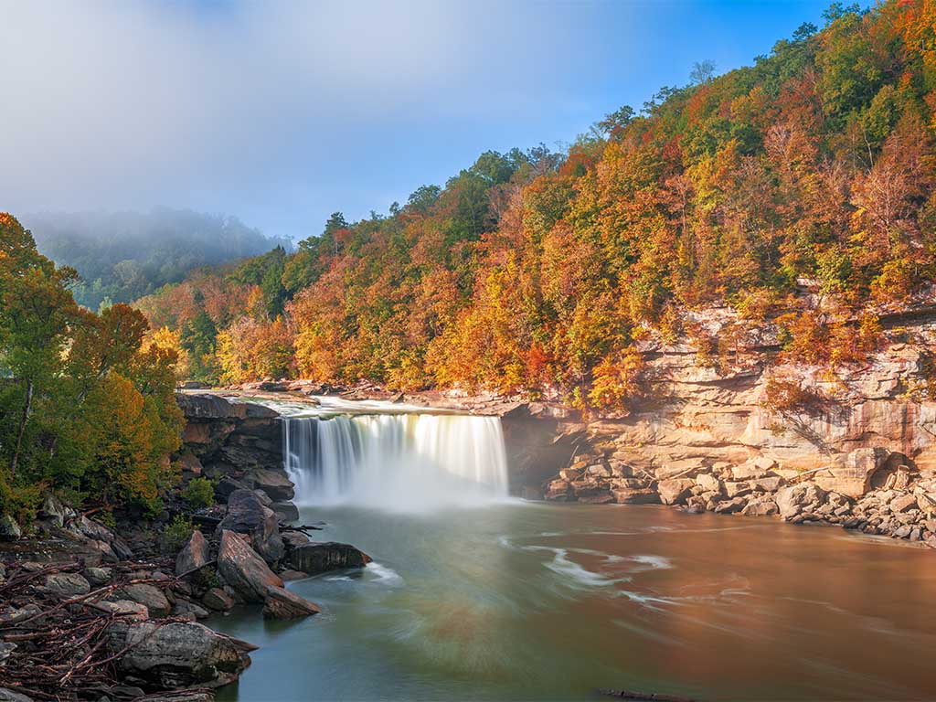 Beautiful Waterfall in Kentucky, Flowing into a Crystal Clear River on a Sunny, Autumn Day